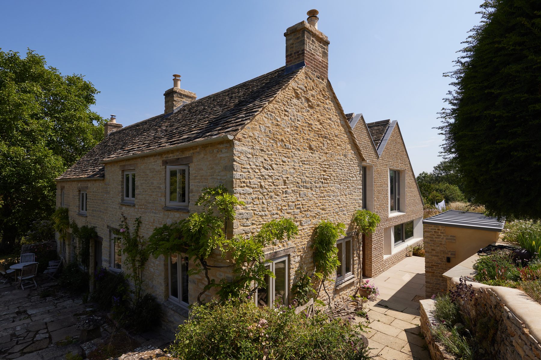 The farmhouse after — the new stone extension uniting old and new