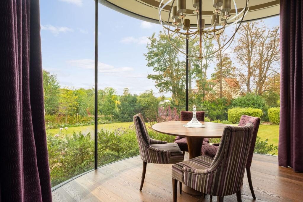 The curved dining bay with full-height glazing to the garden